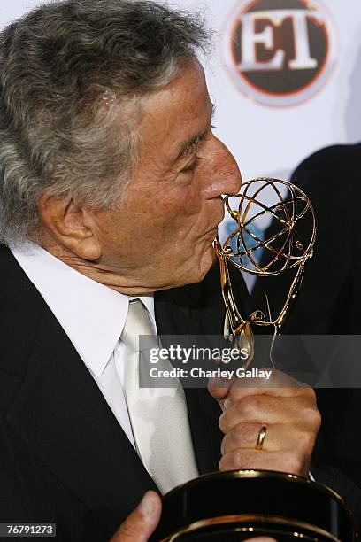 Singer Tony Bennett kisses his Emmy statuette won for 'Outstanding Variety, Music Or Comedy Special' for 'Tony Bennett: An American Classic' at the...