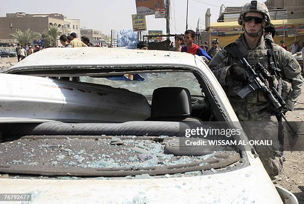 Soldier stands guard at the site of a car bomb attack in Baghdad, 17 September 2007. Iraq today ordered the cancellation of the operating licence of...