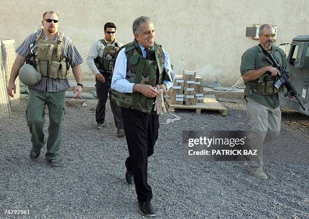 A file picture dated 15 October 2005 shows US Ambassador to Iraq Zalmai Khalilzad, wearing a flack jacket and surrounded by bodyguards from the US...