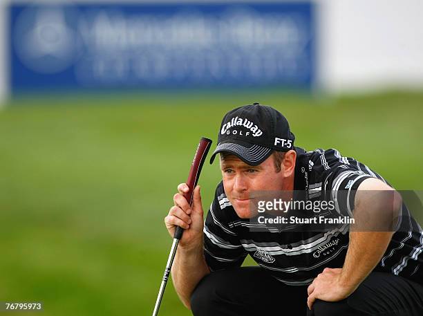 Alastair Forsyth of Scotland lines up a putt during the final round of The Mercedes-Benz Championship at The Gut Larchenhof Golf Club on September...