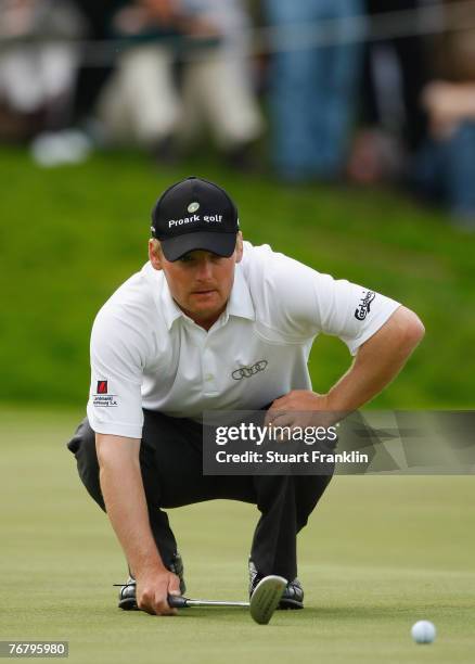 Soren Kjeldsen of Denmark lines up a putt during the final round of The Mercedes-Benz Championship at The Gut Larchenhof Golf Club on September 16,...