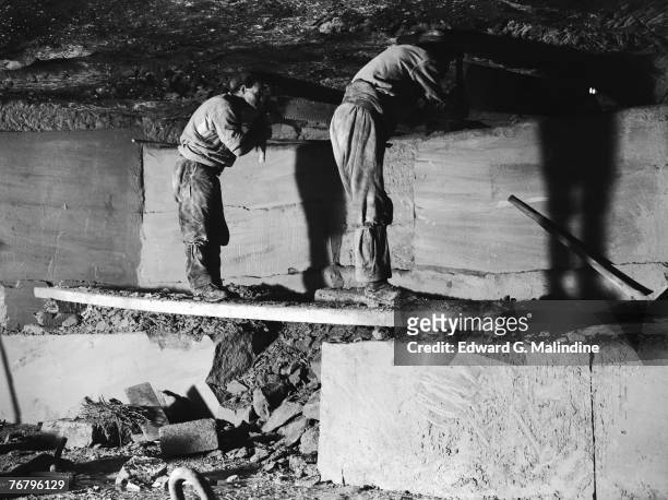 Two quarrymen at work with a frig-bob at Sumsions Monks Park Bath stone quarry in Corsham, Wiltshire, 24th October 1928.