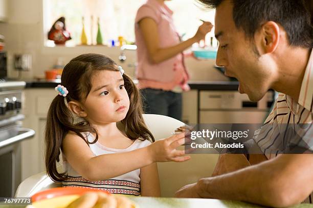 a man and his daughter talking in the kitchen - hand over mouth stock pictures, royalty-free photos & images