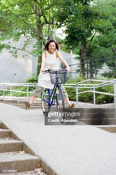 a girl riding a bicycle - japanese women feet stock pictures, royalty-free photos & images