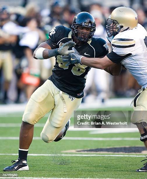 Defensive end Jeremy Thompson of the Wake Forest Demon Deacons tries to rush past tight end Justin Larson of the Army Black Knights during the Demon...
