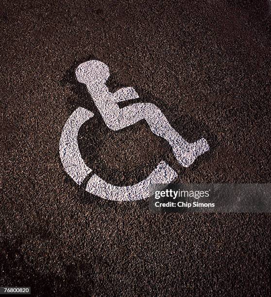 wheelchair symbol on asphalt - handicap parking space stock pictures, royalty-free photos & images