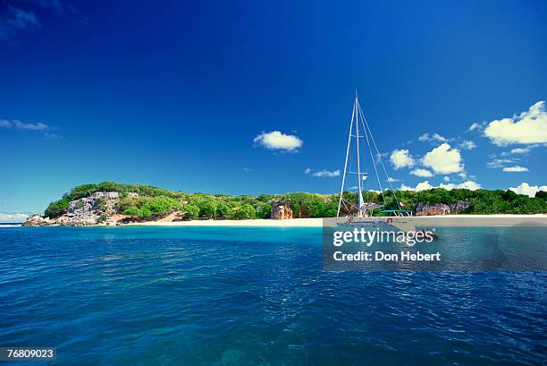 sailboat offshore of island - saint martin stock-fotos und bilder