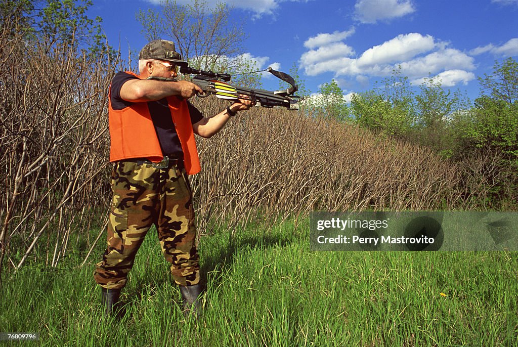 Man aiming a crossbow