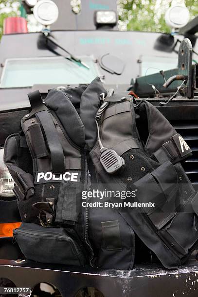 police vest sitting on bumper of armored vehicle - スワットチーム ストックフォトと画像