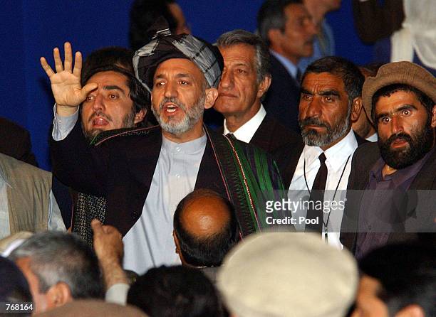 Newly elected Afghan President Hamid Karzai gestures to a crowd after his inauguration at the Loya Jirga grand assembly June 19, 2002 in Kabul,...