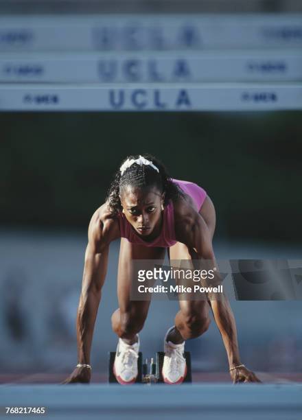 Olympic and Athletics World Championship gold medallist Gail Devers of the United States concentrates as she stands in the starting blocks during a...