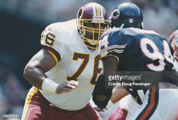 Ed Simmons, Offensive Tackle for the Washington Redskins prepares to block John Thierry, Defensive End for the Chicago Bears during their National...