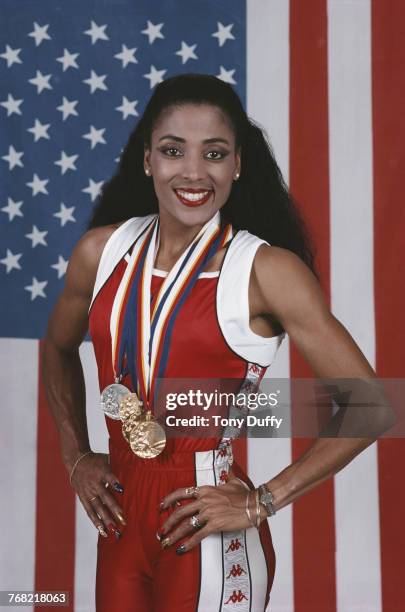 Florence Griffith-Joyner poses for a portrait in front of the Stars and Stripes flag of theUnited States with her medals for winning gold in the...
