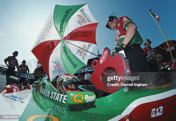 Adrian Fernandez of Mexico sits aboard the Tecate Quaker State Fernandez Racing Reynard 01iHonda in the pits during practice for the Championship...
