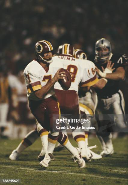 Joe Theismann, Quarterback for the Washington Redskins takes the snap prepares to the throw the ball during the National Football League Super Bowl...