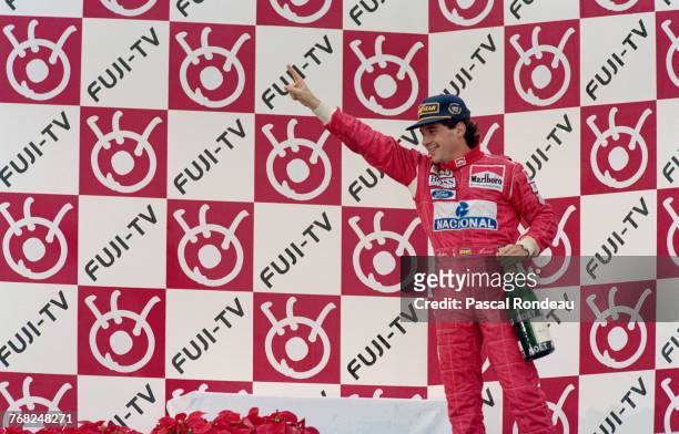Ayrton Senna of Brazil and driver of the Marlboro McLarenMcLaren MP4/8Ford HBE7 V8 stands on the podium after winning the Japanese Grand Prix on 24...