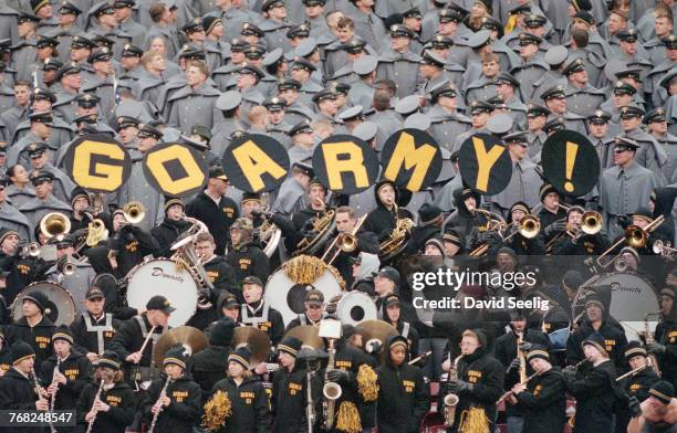 Officer cadets from the United States Military Academy at West Point and their marching band display a Go Army sign during their annual NCAA college...