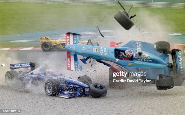 Alexander Wurz of Austria driving the Mild Seven Benetton Playlife Benetton B198 Playlife V10 overturns in the gravel trap during a crash with Jarno...