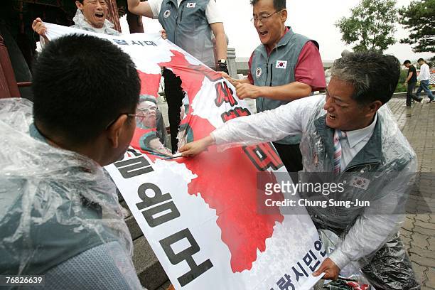 Activists tear a North Korean placard while protesting against North Korea and the upcoming inter-Korean summit near the demilitarized zone...