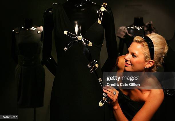 Model views the classic Elizabeth Hurley's safety-pin little black dress as Harrods opens its 'Little Black Dress' exhibition on September 18, 2007...