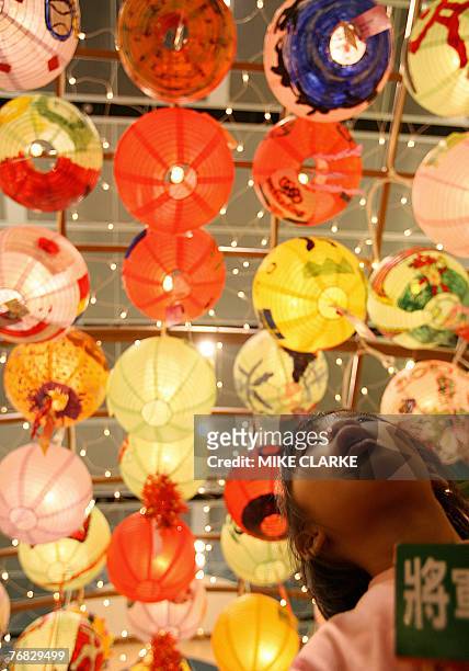 Girl who had taken part in a lantern design competition to celebrate Mid Autumn Festival looks up at her creation at a shopping mall in Hong Kong 18...