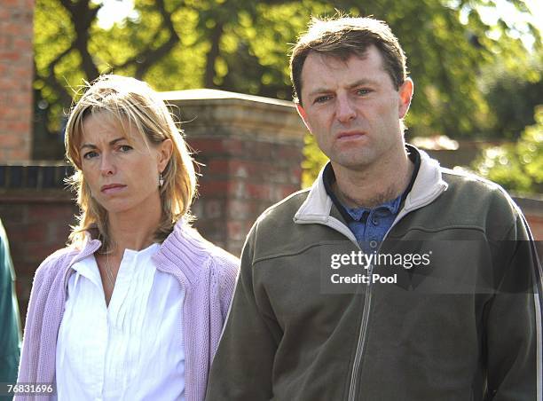 Kate and Gerry McCann walk outside their house as new spokesman Clarence Mitchell, a former BBC journalist, gives a statement to the press, September...