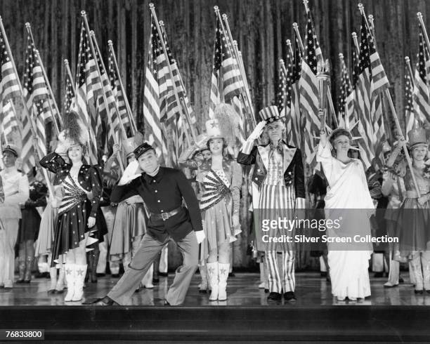 American actor James Cagney stars with Jeanne Cagney , Joan Leslie, Walter Huston, and Rosemary DeCamp in the musical biopic 'Yankee Doodle Dandy',...