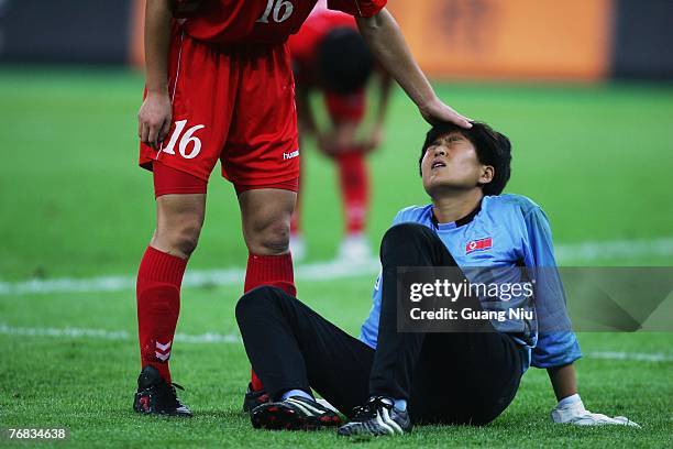 North Korea's goalkeeper Jon Myong-hui is consoled by a teammate during the FIFA Women's World Cup 2007 Group B match against Sweden at the Tianjin...