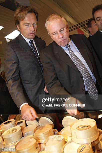 Swiss Justice Minister Christoph Blocher , strongman of the Swiss People's Party , inspects Swiss cheeses along with Jean-Philippe Rochat,...