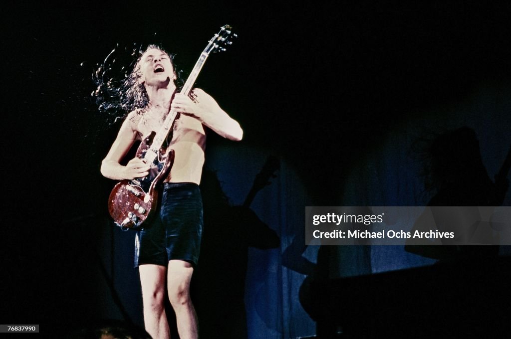 Guitarist Angus Young of AC/DC shreds a solo during a concert on ...