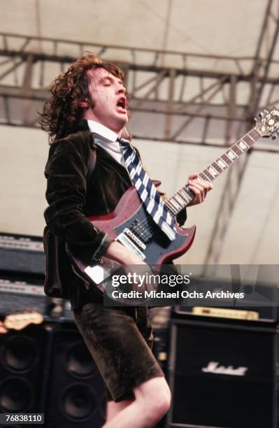 Guitarist Angus Young of rock band AC/DC performs a gig in August 1979 in Hollywood, California.