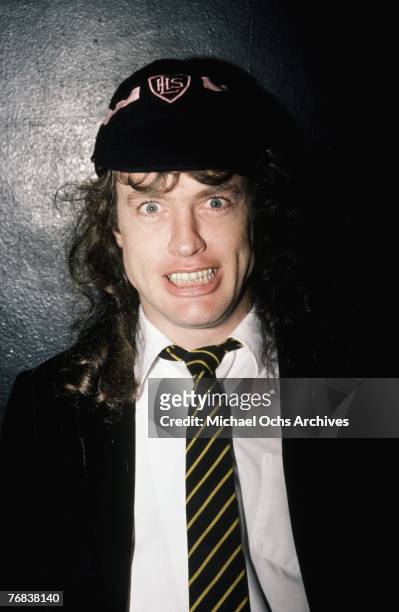 Guitarist Angus Young of AC/DC poses for a photo backstage before a show at the Forum on October 18 in Inglewood, California.