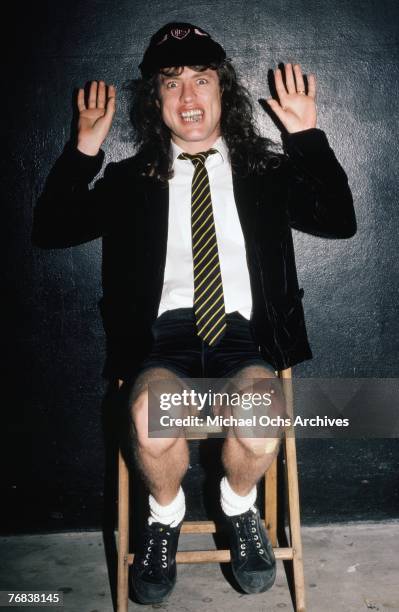 Guitarist Angus Young of AC/DC poses for a photo backstage before a show at the Forum on October 18 in Inglewood, California.