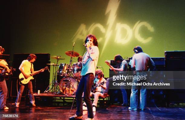 Rhythm guitarist Malcolm Young, drummer Phil Rudd, singer Bon Scott, lead guitarist Angus Young, and bassist Mark Evans of AC/DC rehearse for a gig...