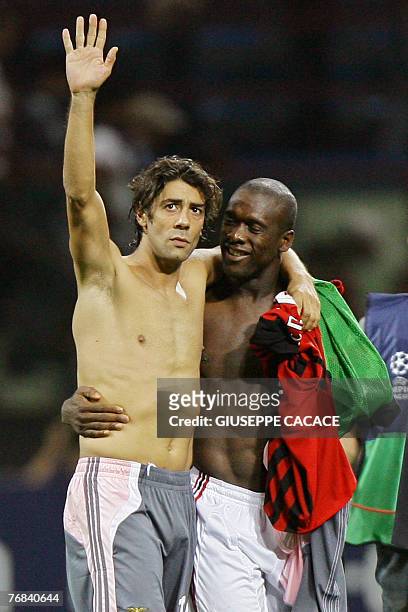 Benfica's midfielder Rui Costa and AC Milan Dutch midfielder Clarence Seedorf wave to the fans after their Champions League Group G match at San Siro...
