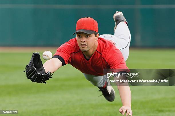 diving catch - catcher stock pictures, royalty-free photos & images