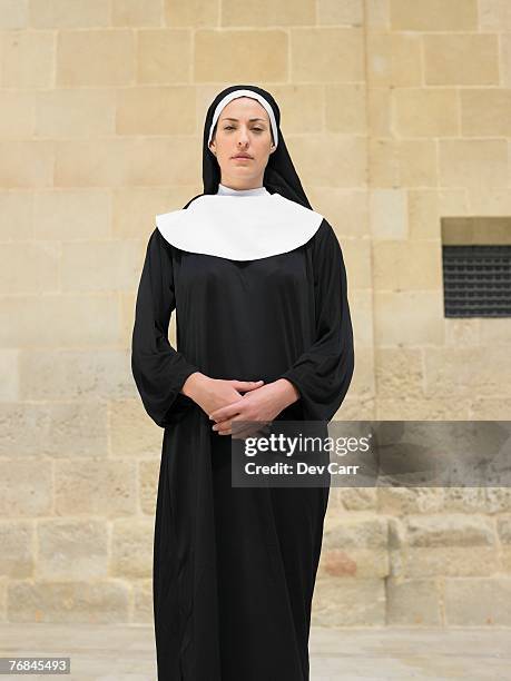 portrait of nun clasping hands looking into camera, alicante, spain, - nun outfit stock pictures, royalty-free photos & images