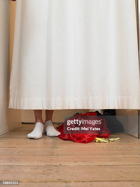 woman standing behind curtain in changing room, low section - kleidung anprobe stock-fotos und bilder