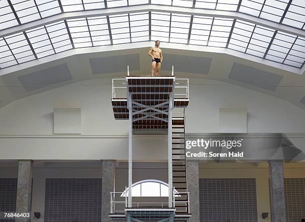 mature man on diving board low angle view - diving board stock pictures, royalty-free photos & images