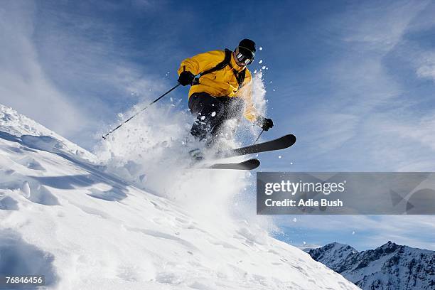 male skiing over mountain ridge - スキー ストックフォトと画像
