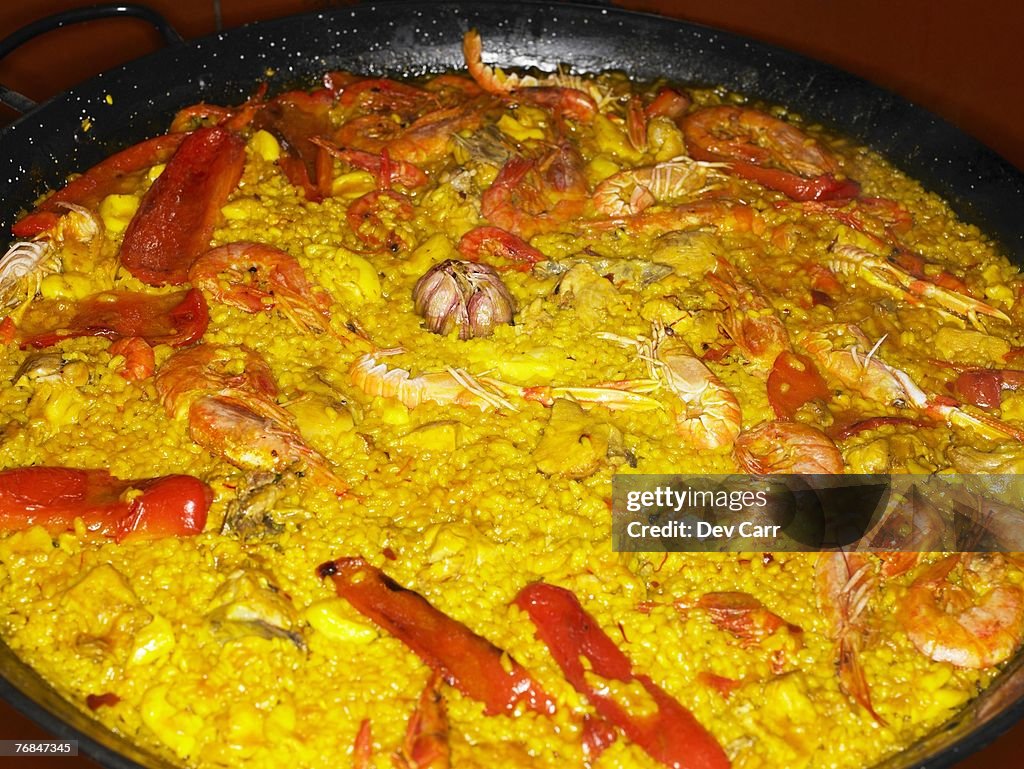 Seafood paella in large pan, close-up