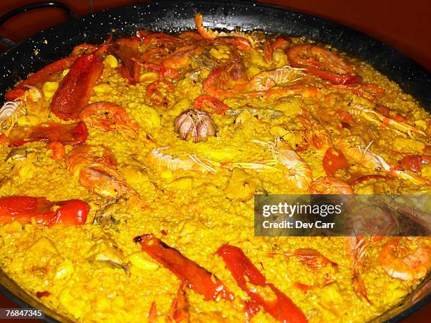 seafood paella in large pan, close-up - paella alicante stock pictures, royalty-free photos & images