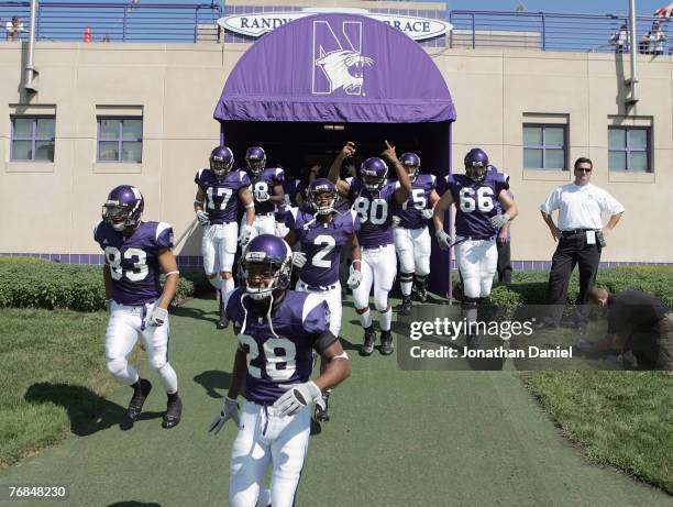 Lee Coleman of the Northwestern Wildcats runs out of the locker room with the team before the game against the Nevada Wolf Pack on September 8, 2007...