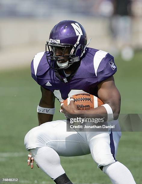 Tyrell Sutton of the Northwestern Wildcats carries the ball during the game against the Nevada Wolf Pack on September 8, 2007 at Ryan Field at...