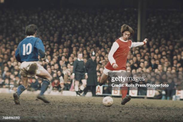 English professional footballer and forward with Arsenal Football Club, Charlie George pictured in action on the pitch in a first division match...