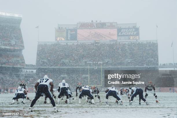 With snow falling on the field Steve McNair, Quarterback for the Tennessee Titans calls the play on the line of scrimmage against the Cleveland...