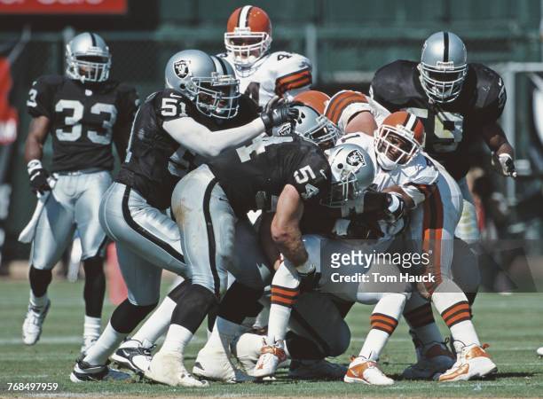 Greg Biekert and Lance Johnstone of the Oakland Raiders tackles Travis Prentice Running Back for the Cleveland Browns during their National Football...