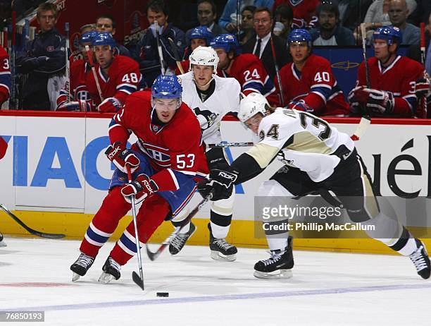 Cory Urquart of the Montreal Canadiens dekes around Jonathan Filewich of the Pittsburgh Penguins with the puck during the second period of a...
