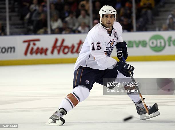 Jarret Stoll of the The Edmonton Oilers passes the puck up the ice during the second period of preseason NHL action against the Toronto Maple Leafs...