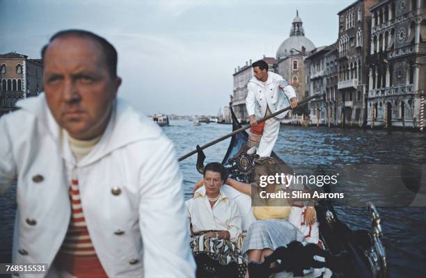 Countess Ann Maria Cicogna with her daughter Marina, members of an old Doge family, are rowed to a cocktail party in their gondola on the Grand Canal...